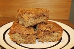 Apple Coffee Cake with Brown Sugar Glaze being served on white plate sitting on wood table