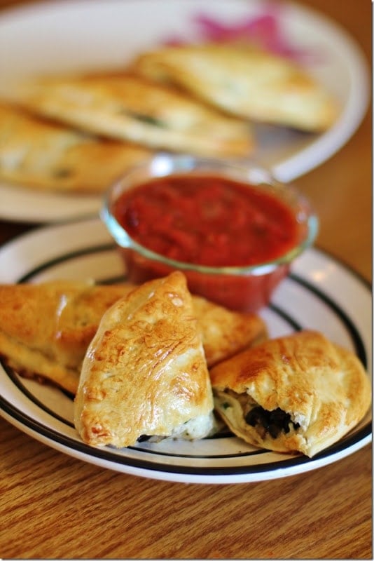Easy Calzones served on a round white plate on a wood table