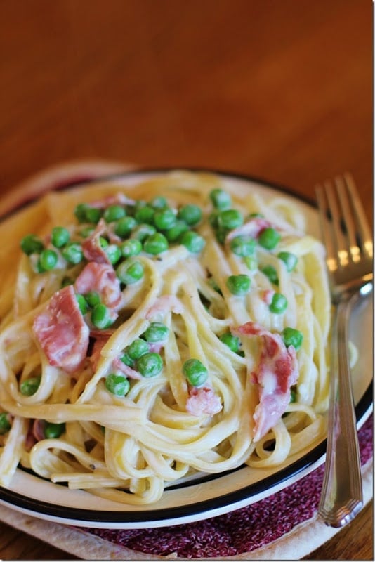 One Skillet Chicken Alfredo with Peas on a white plate