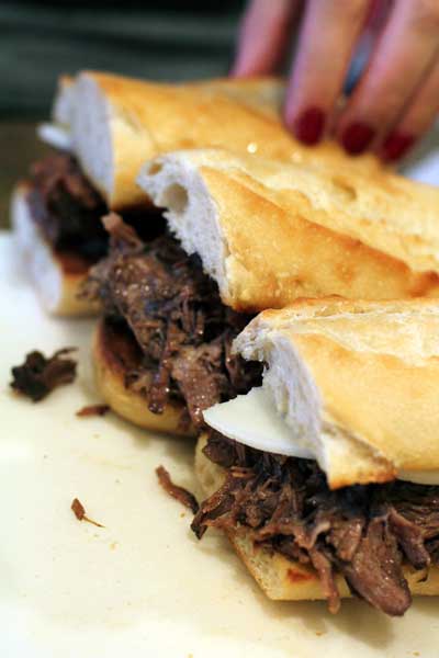 assembled French Dip sandwiches on a cutting board