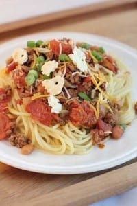 plate of Slow Cooker Cincinnati Chili on a white plate on a wood tray