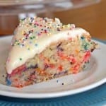 Confetti Cake on a white plate with a glass cake pan in the background