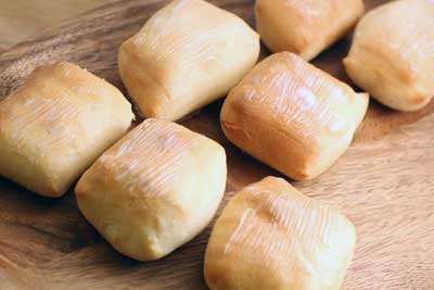 Copy Cat Texas Roadhouse Rolls on a wood plate