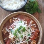 Lasagna Soup in a bowl sitting on a wood tray next to a bowl of Cottage cheese