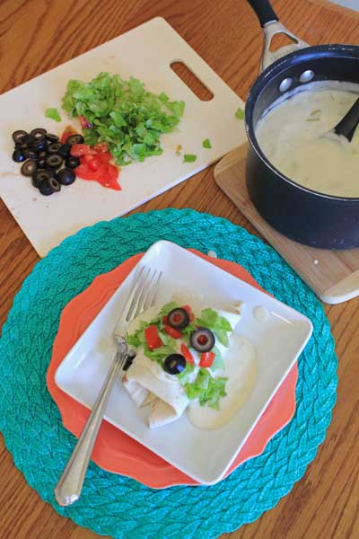 Take your fiesta to another level by smothering these beef and bean burritos in a sour cream and green chili sauce.