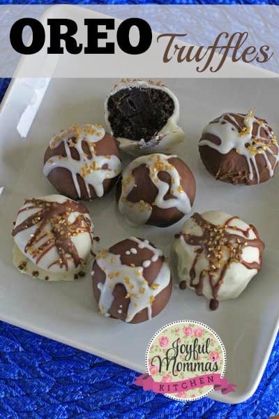 Seven Oreo Truffles sitting on a square white plate and blue placemat