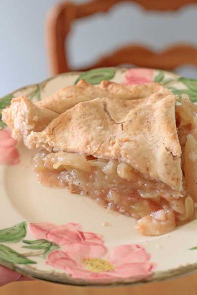 Perfect Apple Pie sitting on a colorful plate on wood table