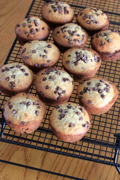 cooling rack full of Banana Bread Muffins on a wood table