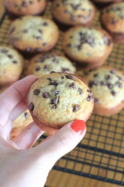 hand holding Banana Bread Muffins in front of blurred background