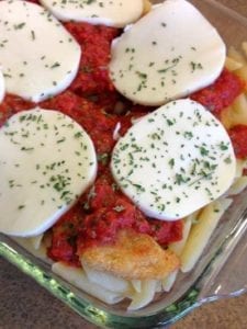 Cheater chicken parm in a glass pan with all ingredients before baking
