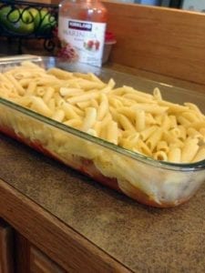 glass pan with penne noodles sittin on counter