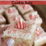 Candy cane kiss bars text with hand holding a candy cane kiss bar