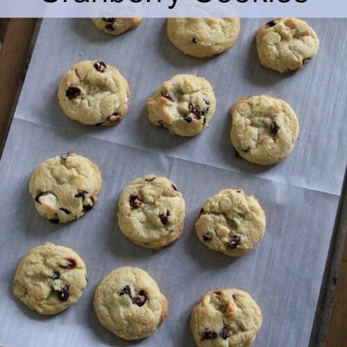 White Chocolate Cranberry Cookies text with cookies on a cookie sheet