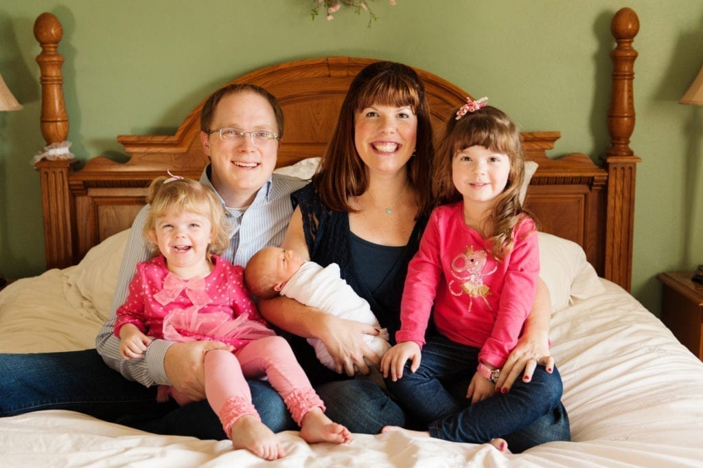 Lexi and Clint holding three kids for a family photo