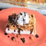 Fried Ice Cream Cake on a red plate with a glass pan in the background
