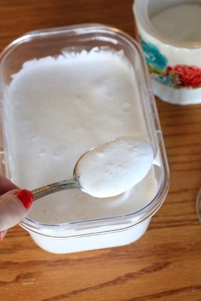 hand holding spoon full of home made whipped cream