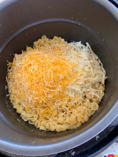 cheese being added to the noodles cooked for Instant Pot Mac and Cheese