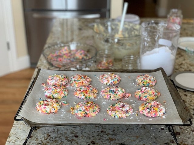 12 colorful cookies on a baking sheet