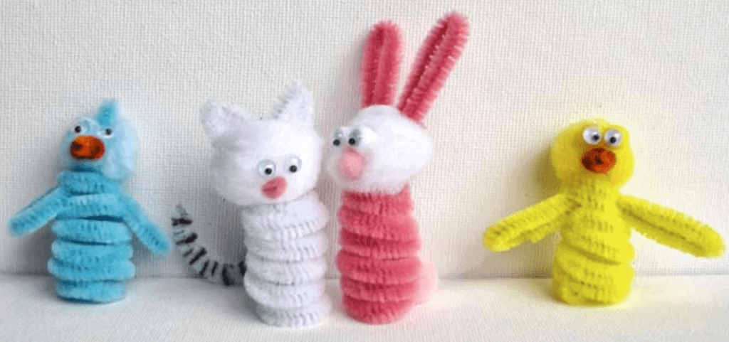 Easter craft of a Blue bird, white cat, Pink bunny  and yellow duck made out of pipe cleaner against a white back drop.
