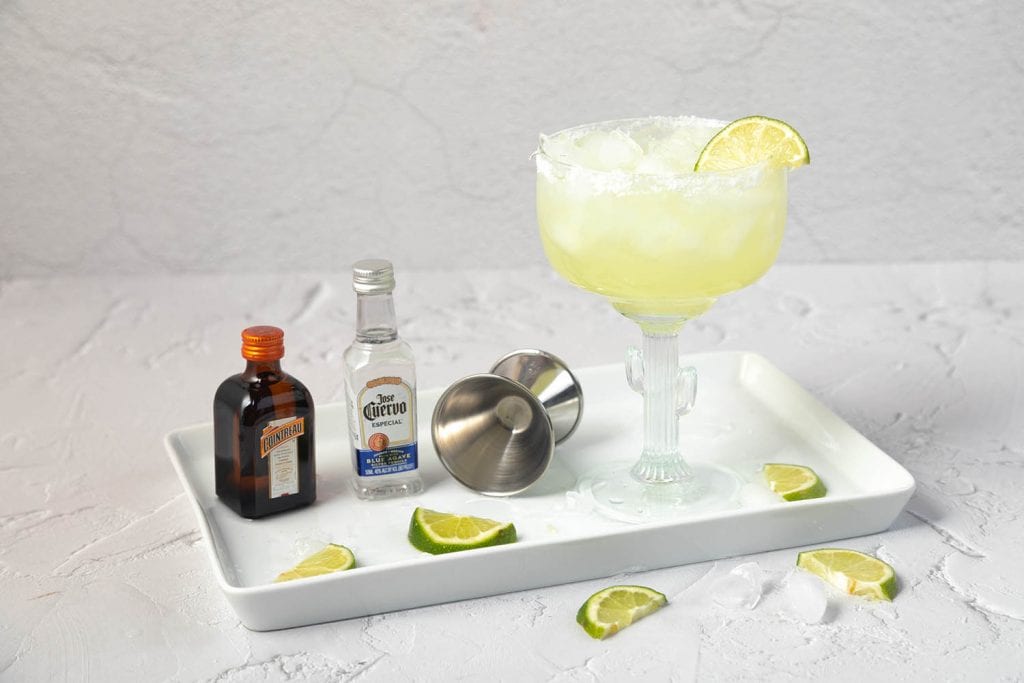 margarita ingredients on a white plate set on a white countertop
