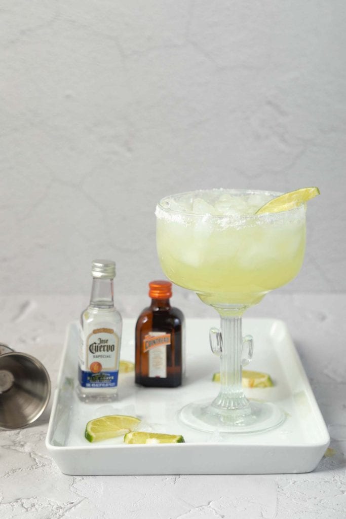 margarita ingredients on a white plate set on a white countertop