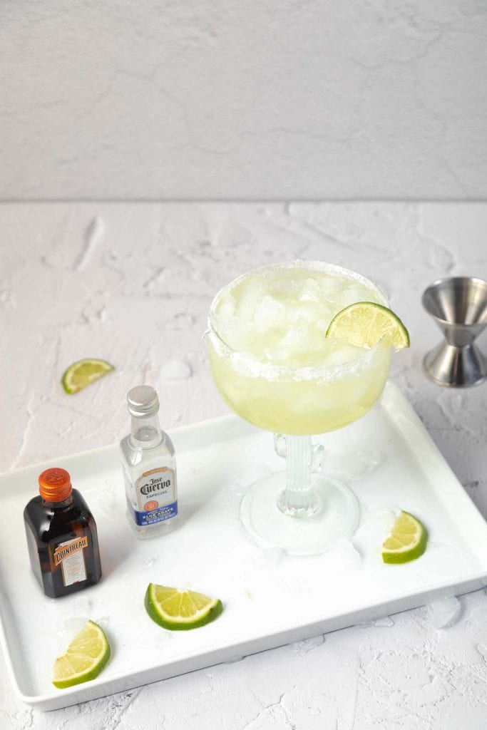 margarita ingredients on a white plate set on a white countertop