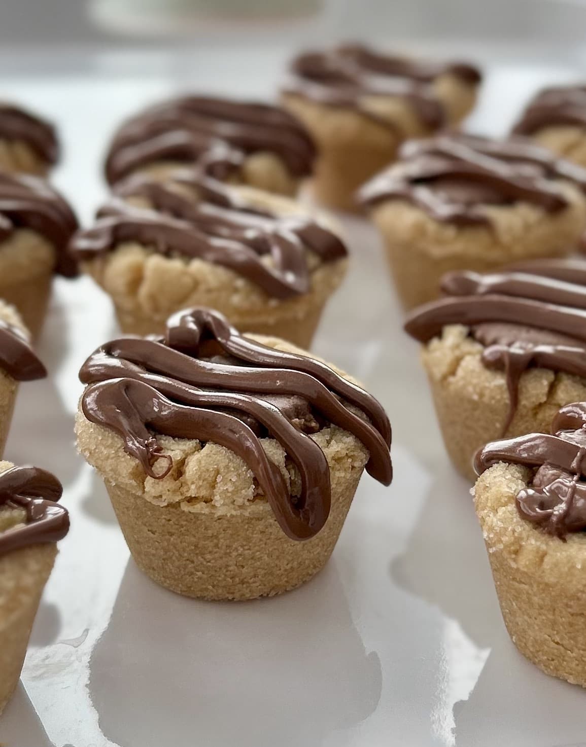 close up of Reese's peanut buter cookie bites finished with a drizzle of milk chocolate