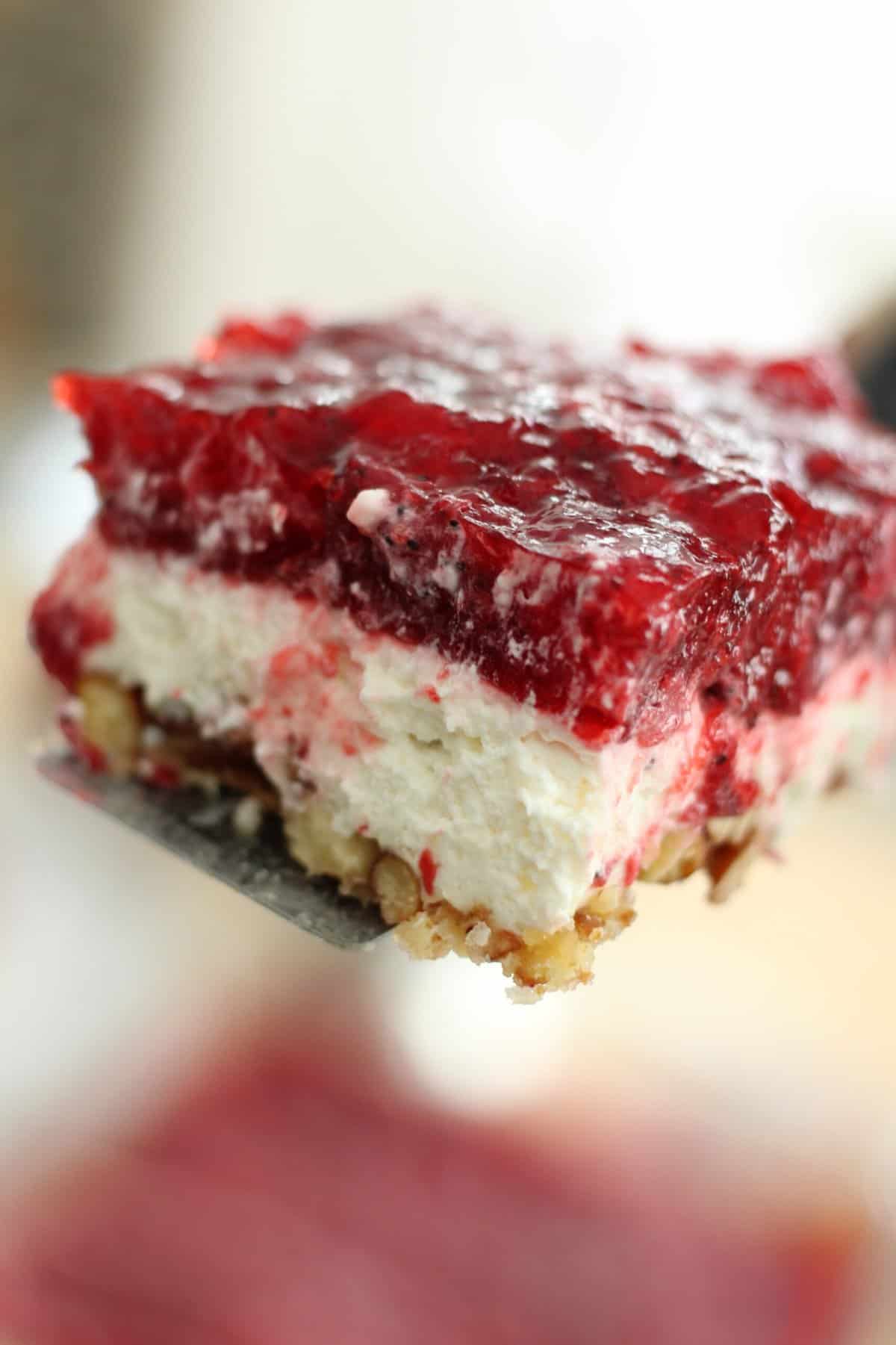 Layers of pretzel crust, cream cheese filling, strawberry jello topping