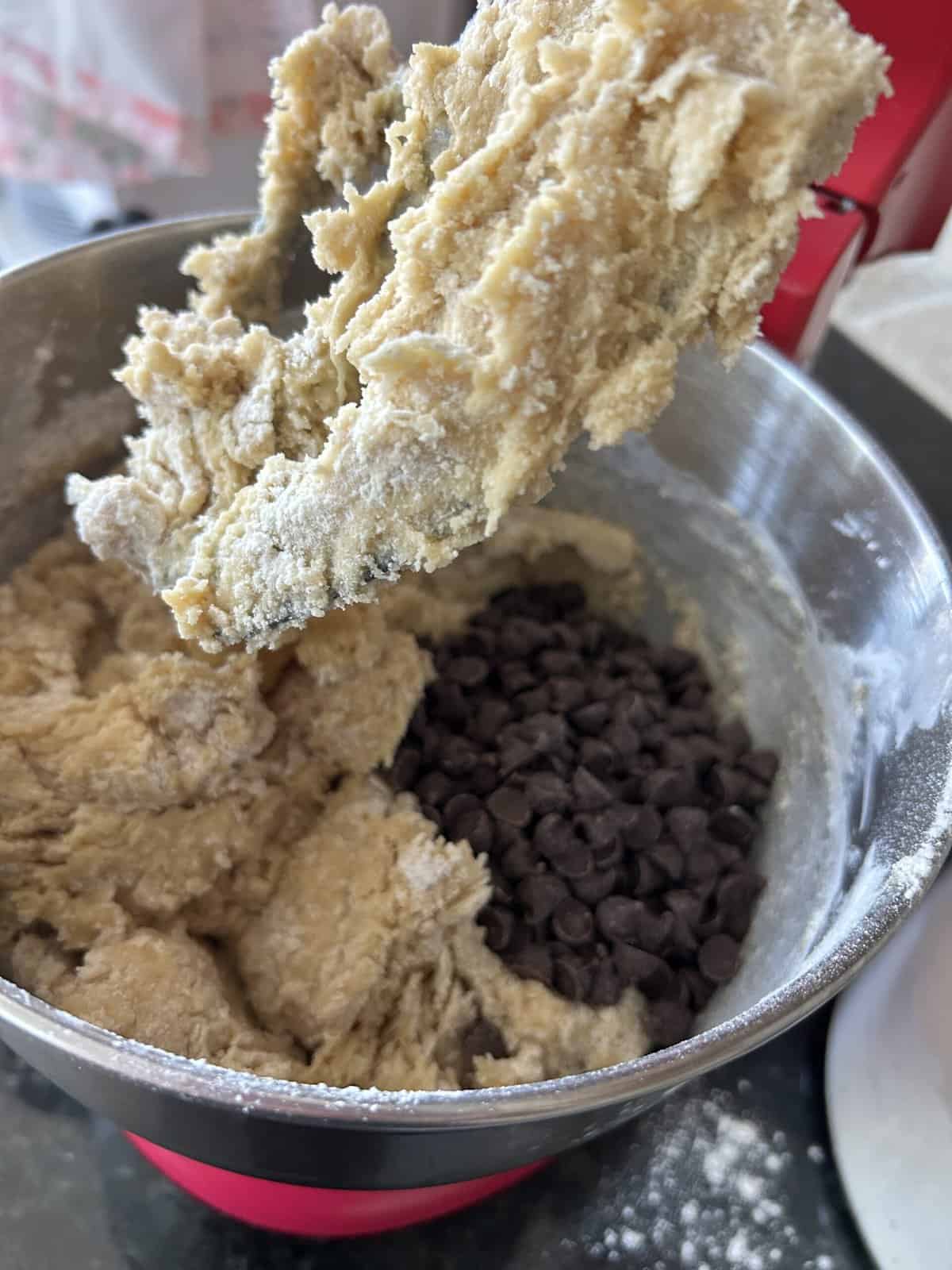 Cookie dough in a stand mixer and chocolate chips