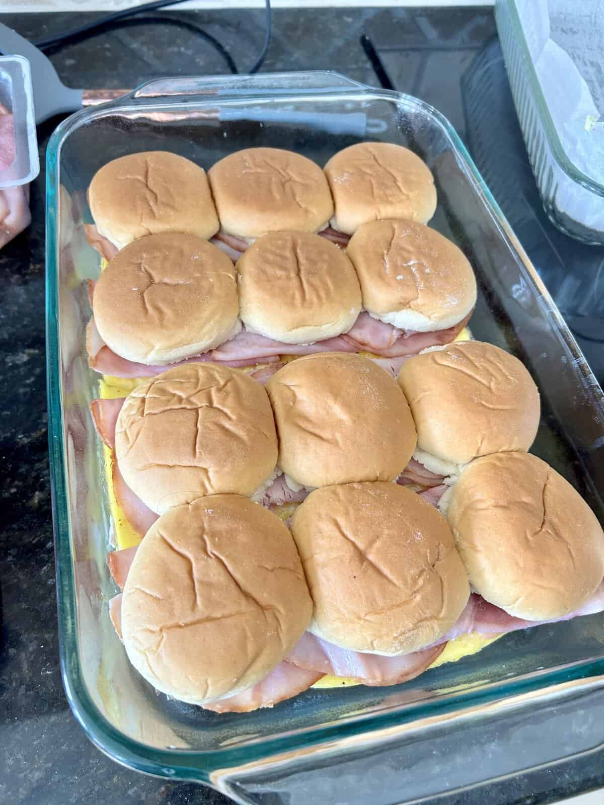 glass baking dish with layered breakfast sandwiches